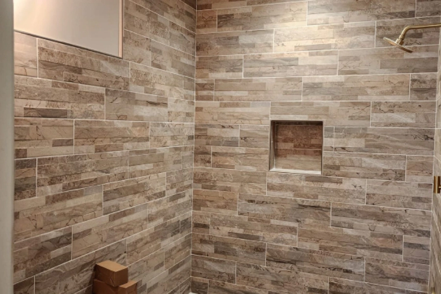 batrhroom with some tiled walled colored beige and brown